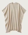 HIGHLAND handwoven yak wool poncho flat lay, front view, natural ivory with V-neckline and hand-knotted fringe hem — Traces of the World
