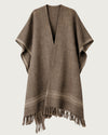 AURORA handwoven yak wool poncho flat lay, front view, warm brown tone with natural stripe border and hand-knotted fringe — Traces of the World
