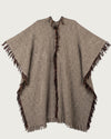 SANTOS artisan wool poncho flat lay back showing handwoven texture and fringe edges, stone grey tones — Traces of the World
