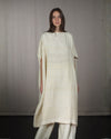 Full-lenght front view of the nmaculadadress, showcasing its architectural squared silhouette nd raw silk texture. 