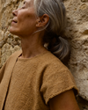 Detail shot of the coyuchi top, focusing on the organic cotton weave and the sophisticated round collar. 