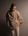Front view of the DESI Kimono Jacket, highlighting the overlapped closure with three buttons and the artisanal fringe detailing on the seams.