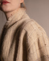 Extreme close-up of the DESI jacket, showing the high-quality interwoven stripes and the organic texture of the raw silk and wool blend.