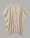 Front view of the Highland poncho in natural beige yak wool, showing the two-panel construction and soft handspun texture. 