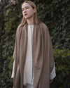 Side profile of the MARIA shawl, emphasizing the breathable open-weave fabric and comfortable loose fit.