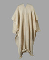 Flat back product shoot of the nube poncho handwoven with Desi Wool and fringes. 
