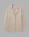 Flat lay front view of the Sofia jacket, displaying its minimalist construction and natural cream color. 