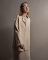 Side view of the Sofia jacket, showcasing the straight sleeves and the sophisticated silhouette of the handwoven textile. 