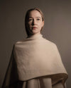 half-body front view of a model wearing the light beige Highland Yak Wool Poncho, ahndwoven in Ladakh India. 